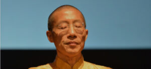 Master Mingtong Gu in a serene meditative state, embodying the essence of Wisdom Healing Qigong practice for inner peace and mindfulness.