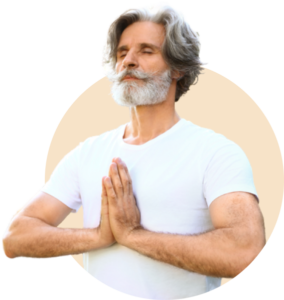 Serene man with gray hair and beard practicing mindfulness in a meditative pose, hands pressed together, symbolizing peace and inner balance.