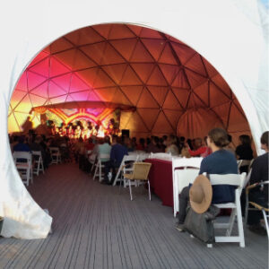 Inside the Chi Center Dome, attendees gather for an immersive healing and meditation session, illuminated by vibrant lighting and energy