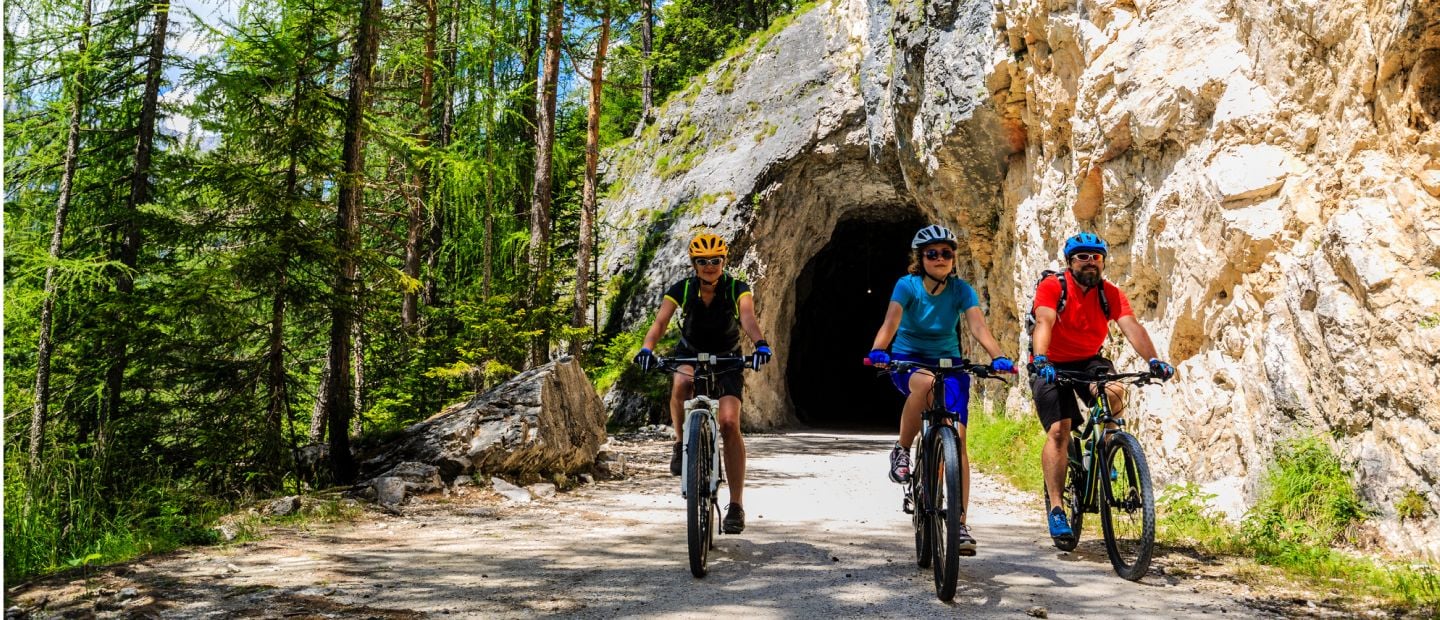 A group of people riding bikes through a tunnel.