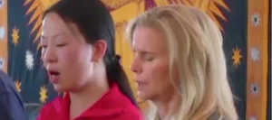 Two women standing next to each other practicing Qigong