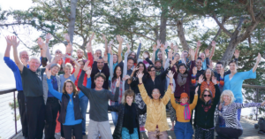 The Chi Center team including Master Mingtong Gu standing infront of the grandmother tree