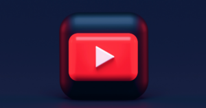 3D YouTube play button icon with red and white accents on a sleek dark blue background.