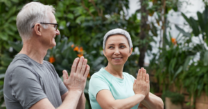 A couple practicing Wisdom Healing Qigong outdoors