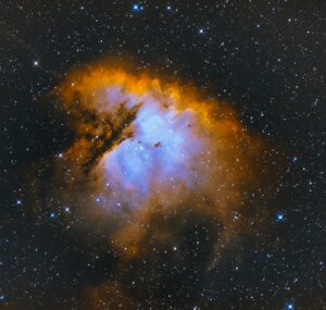Vivid image of a cosmic nebula with brilliant blue and orange hues, surrounded by countless stars in the vast expanse of space, evoking awe and wonder of the universe.