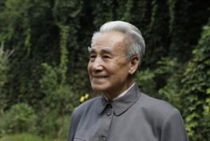Image of Dr. Pang, founder of the Qigong healing system, with a serene outdoor background reflecting wisdom and natural harmony.