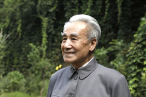 Image of Dr. Pang, founder of the Qigong healing system, with a serene outdoor background reflecting wisdom and natural harmony.