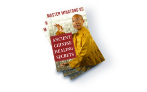 Promotional image featuring Master Mingtong Gu holding a healing pose, showcasing a book titled 'Ancient Chinese Healing Secrets,' highlighting Qigong practices and traditional Chinese wisdom for health and well-being.