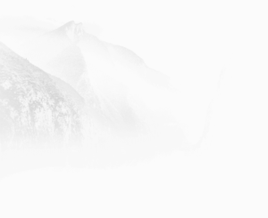 Serene black-and-white image of mist-covered mountains, capturing the essence of tranquility and natural beauty in a minimalist landscape.