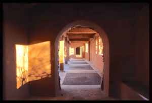 Golden sunset light streaming through multiple archways at The Chi Center casts intricate shadows and highlights the structure's peaceful, architectural elegance.
