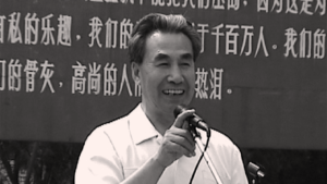 Dr. Pang Ming, founder of Zhineng Qigong, smiling while speaking at an event. A moment capturing wisdom, joy, and leadership in Qigong practice