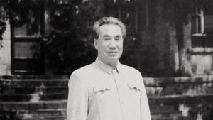Dr. Pang Ming, founder of Zhineng Qigong, standing outdoors with a serene expression, symbolizing wisdom and the essence of Qigong practice.